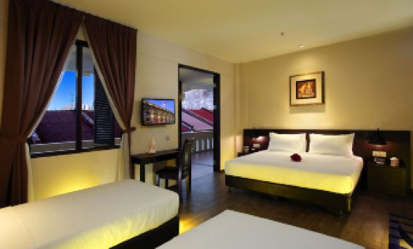 a modern hotel room with two beds , a window , and a tv , all lit up at night at Kimberley Hotel Georgetown