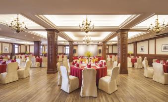 A ballroom is set up with tables and chairs for an event at the hotel or another location at Pacific Hotel