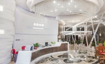 The lobby features a large white and gold chandelier suspended from the ceiling at Hisoar Hotel