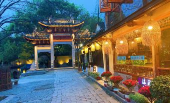A city illuminated by lanterns at night, with streets and buildings aglow at Zhouzhuang Latte Play Stone Mulan Hotel