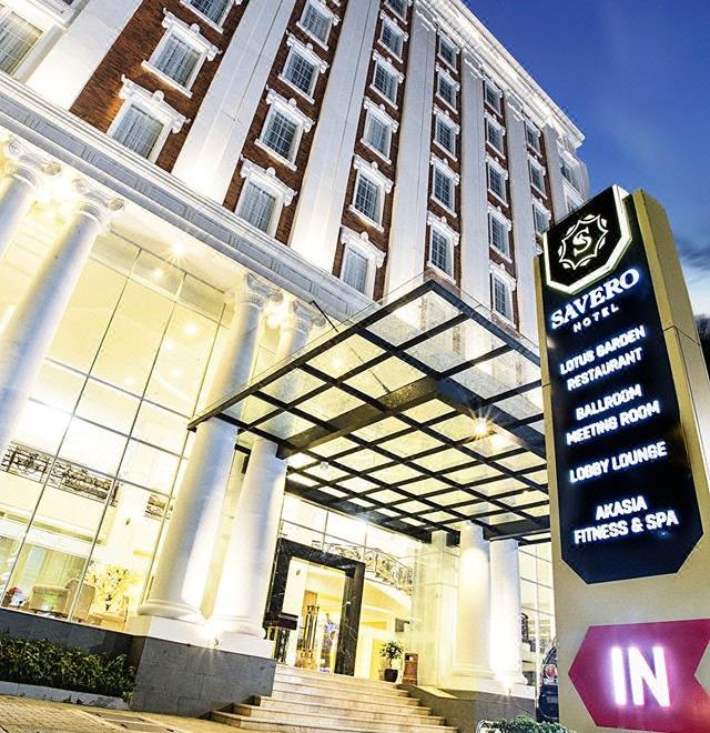 "a large hotel building with a sign that reads "" xaverio "" prominently displayed on the front" at Savero Hotel Depok