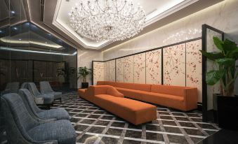 The modern lobby features a large chandelier and a seating area in the center, adorned with ornate decorations at V Hotel Lavender