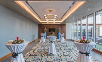 a room with a long table and chairs set up for a reception or event at Neelkanth Sarovar Premiere