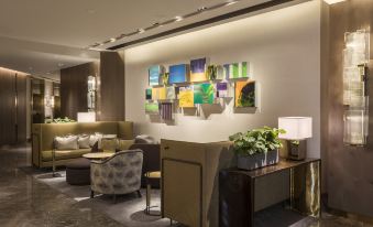 The lobby features couches and tables in the center, accompanied by an entrance at Hyatt Centric Victoria Harbour Hong Kong