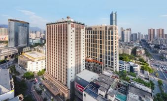 aerial view of a city with tall buildings and a hospital in the center , surrounded by other structures and roads at Fuzhou Hotel