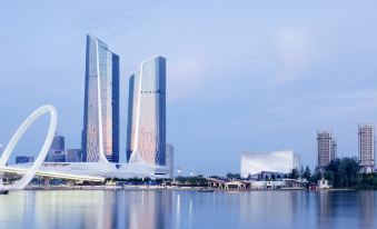 At sunset, there is a picturesque view of buildings and skyscrapers in the background from the water at International Youth Convention Hotel (Nanjing International Youth Cultural Centre)