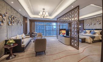 A spacious room with a connected living area, dining space, and kitchenette at Hainan Grand Hotel