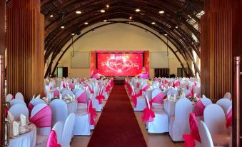 a large banquet hall with multiple tables and chairs set up for a formal event at Indochine Hotel