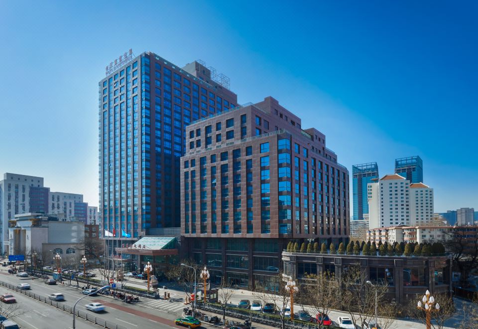 There is a large building in the center surrounded by other buildings, with one building on top at Bai Fu Yi Hotel