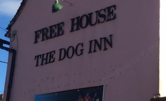 "a building with a sign that reads "" free house the dog inn "" prominently displayed on it" at The Dog Inn