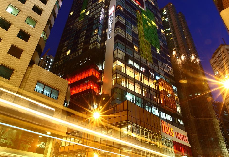 city at night with tall buildings and people on the street in front at ibis Hong Kong Central and Sheung Wan Hotel