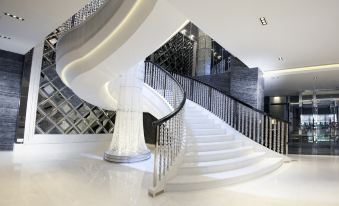 The modern home features a staircase with a series of steps on each floor at Dorsett Tsuen Wan