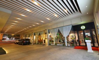 The restaurant entrance features large windows and an arched doorway that leads to another area at Metropolo Dahua Hotel Shanghai