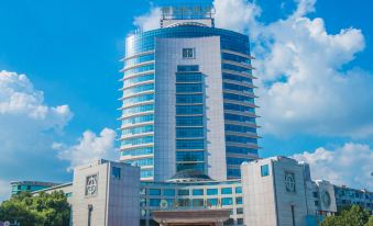 "There is a large building with the word ""hotel"" on the front and another building behind it" at Longyou International Grand Hotel