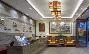 The lobby or reception area at Arabian Nights Hotel and Restaurant is adorned with large paintings at Zhenmei Resort Chain Hotel(Yangshuo West Street AiYuan Store)