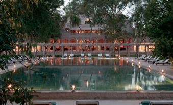 At night, the building has a large pool that is illuminated and reflects light on its water at Amanbagh