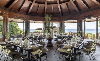 a large dining room with multiple tables and chairs , all set up for a formal event or a wedding reception at Shangri-La Boracay