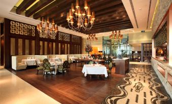 The restaurant features an elegant dining room with tables, chairs, and chandeliers hanging from the ceiling at The Venetian Macao