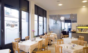 a large dining room with wooden chairs and tables set up for a formal event at PRIMAVERA