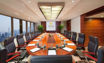 A spacious conference room equipped with a long table and chairs is available for meetings and other business purposes at Jin Jiang Tower