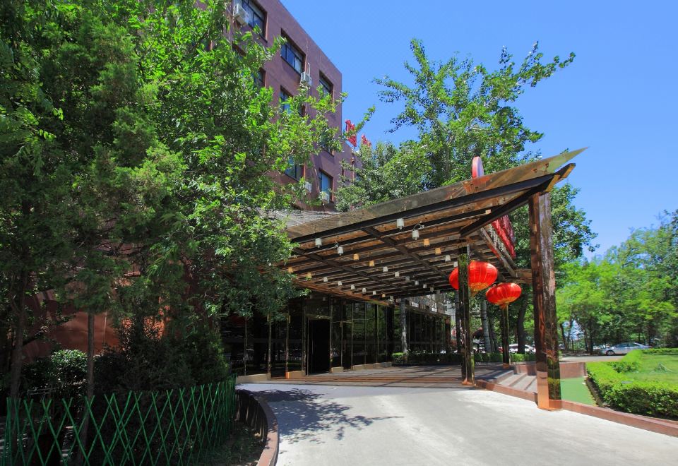 The hotel entrance features an outdoor view and a stone walkway that leads to another area at Capital Airport International Hotel