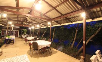 an outdoor dining area with tables and chairs set up for a group of people at Baan Suan Nuanta