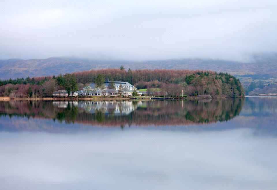 a large body of water with a small island in the middle , surrounded by trees at Harvey's Point