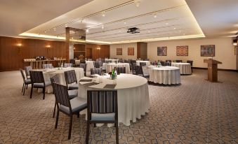 a large conference room with multiple round tables and chairs , set up for a meeting or event at The Setai Tel Aviv, a Member of the Leading Hotels of the World
