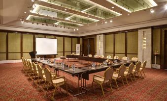 a large conference room with a long table and chairs arranged in a semicircle , providing ample seating for attendees at Pearl Continental Hotel Malam Jabba