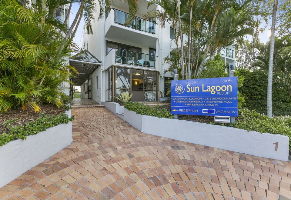 "a building with a sign that reads "" sun lagoon "" prominently displayed on the front of the building" at Sun Lagoon Resort