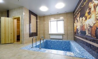 a modern bathroom with a blue mosaic bathtub , a window , and a painting on the wall at Vernisage