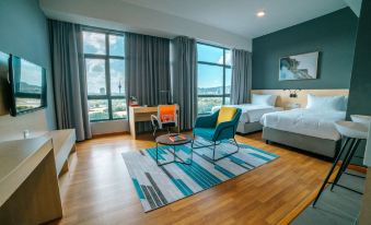 a modern bedroom with hardwood floors , a large window , and a desk in the corner at Swiss-Belhotel Kuantan