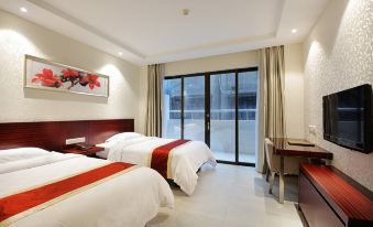 The bedroom features double beds and large windows that provide a view of the pool area at Na Fang Da Sha Hotel
