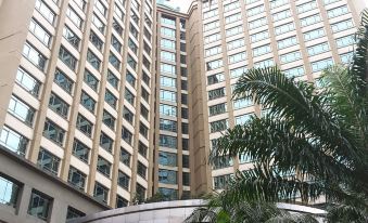 There is a large building with a hotel entrance, flanked by other buildings on both sides at Eastin Hotel Kuala Lumpur