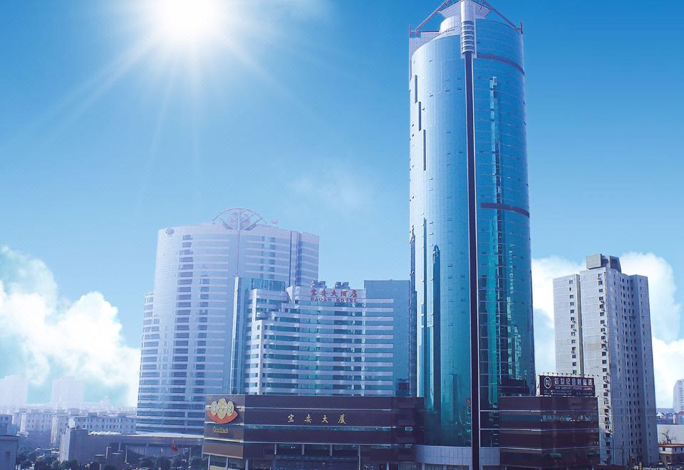 On one side of the city, there is an office building surrounded by tall buildings at Shanghai Baoan Hotel