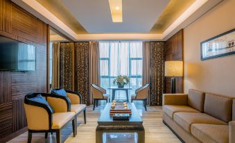 a modern living room with wooden furniture , including a couch , chairs , and a coffee table at Wellington Hotel