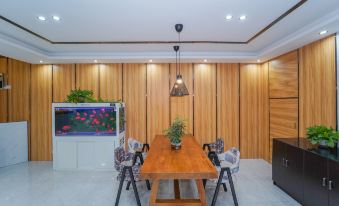 In the living room, there is a large wooden table and chairs, complemented by modern wood paneling on both at Super 8 Hotel (Shanghai Pudong Airport Chenyang Road)