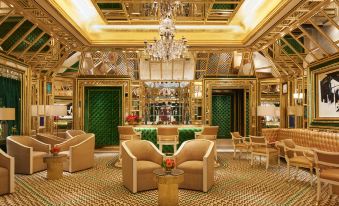 The hotel lobby features elegant furniture, including chairs, chandeliers, and other luxurious pieces at Wynn Palace