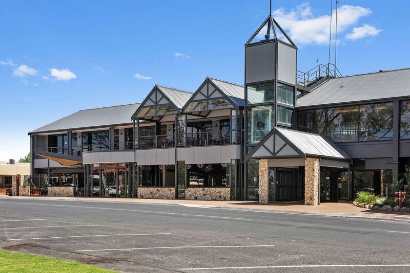 a modern building with a tower and balconies , situated on a street corner in a town at Berri Hotel