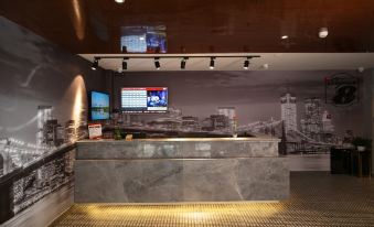 The lobby features a bar and a reception desk with an illuminated wall behind it at Super 8 Hotel Premier (Beijing Workers' Stadium Sanlitun Chunxiu Road)