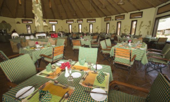 a large dining room with tables and chairs arranged for a group of people to enjoy a meal together at AA Lodge Amboseli