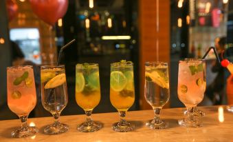 a table is set with five different types of drinks , including lemonade , water , and lemonade at Lucen