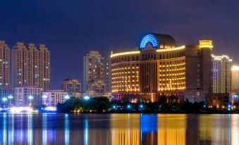 The city's illuminated skyline and buildings create a captivating view at night at Grand Metropark Guofeng Hotel, Tangshan