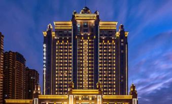 The building housing a hotel is illuminated by neon lights during the night at Glory Charm Hotel