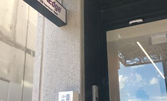 "a storefront with a sign that says "" city life "" and a glass door leading into the building" at City Edge Box Hill Apartment Hotel