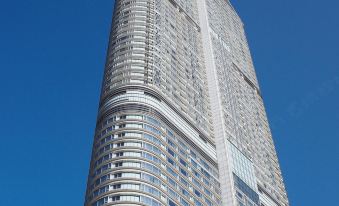 There is a tall building with the sky in front and another skyscraper behind it at Hyatt Regency Hong Kong, Tsim Sha Tsui