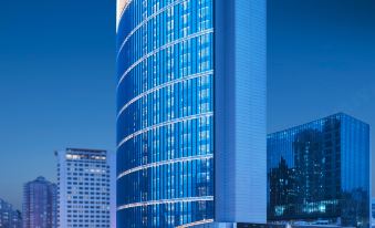 A large building with an illuminated city view at night at Amara Signature Shanghai