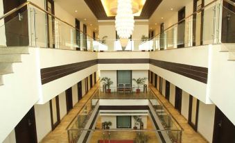 a modern hotel lobby with multiple floors , multiple balconies , and a staircase leading to the second floor at Hotel La