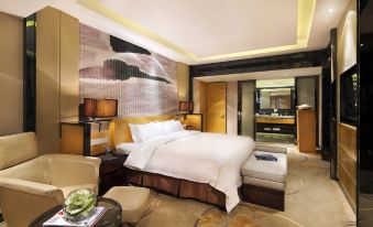 There is a large bed in the middle room, with an attached sitting area and bathroom located behind it at Tianyuan Hotel