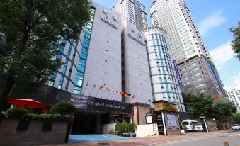 "a tall building with a sign that says "" plaza hotel "" on the front , surrounded by other buildings" at Symphony Hotel